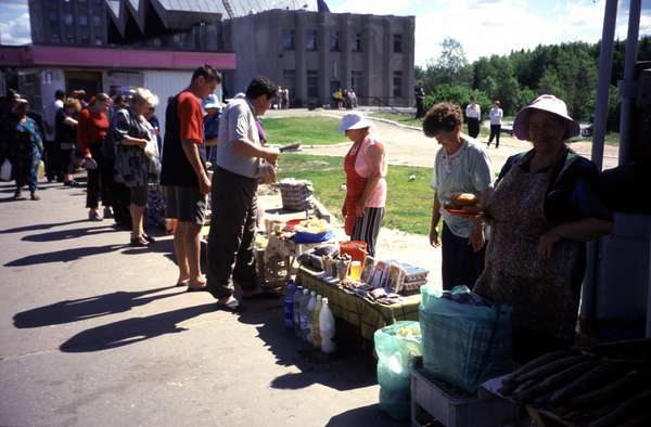photo of Russia, along the trans Siberian railway, food market vendors in a train station in Siberia