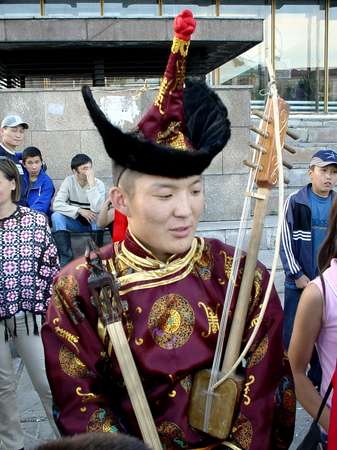 photo of Tuva, Kyzyl, theatre, Dembildei Khoomei festival 2002, Tuvan throat singing musician in traditional dress with music instrument